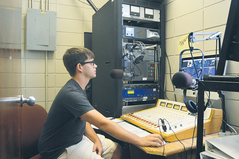 Austin Ledet the Junior Assistant Music Director for KNSU takes his shift Tuesday afternoon in the KNSU workstation.