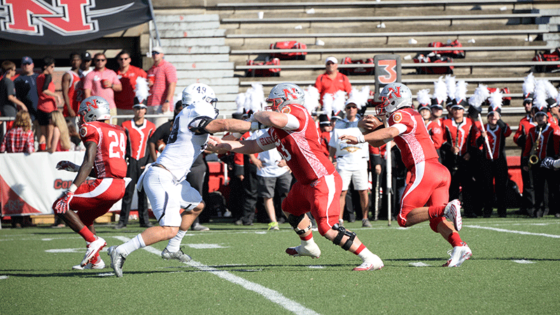 Offensive lineman #63 Ryan Hanley, sophomore from Metairie, blocks for quarterback #9 Chase Forcade, freshman from Metairie, at the homecoming football game October 8 at John L. Guidry Stadium.