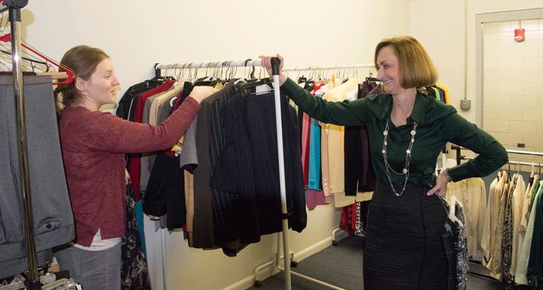 Assistant Dean of the College of Business Administration Krisandra Guidry, on the right, assists Marketing senior, Page Garcia in finding an outfit at the Business Closet January 2.