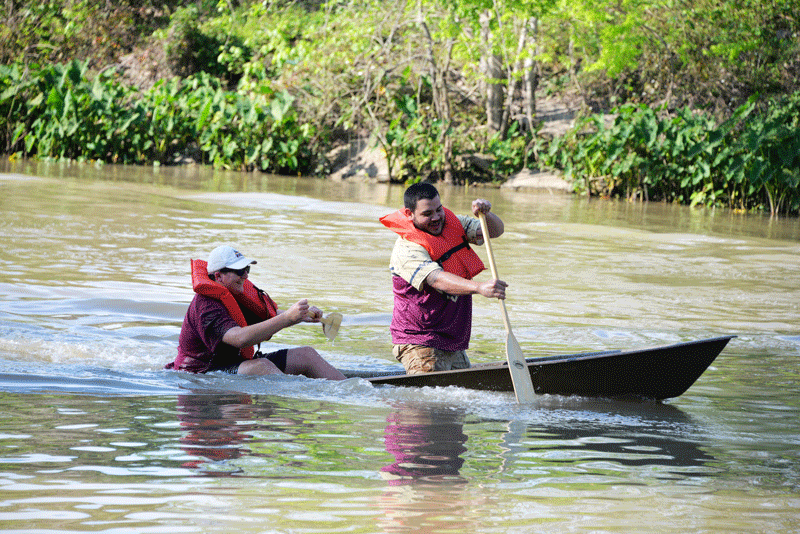 Landon Foster (left) and Joshua Dimattia (right) of Kappa Alpha fraternity compete in the annual Greek Pirogue Races.