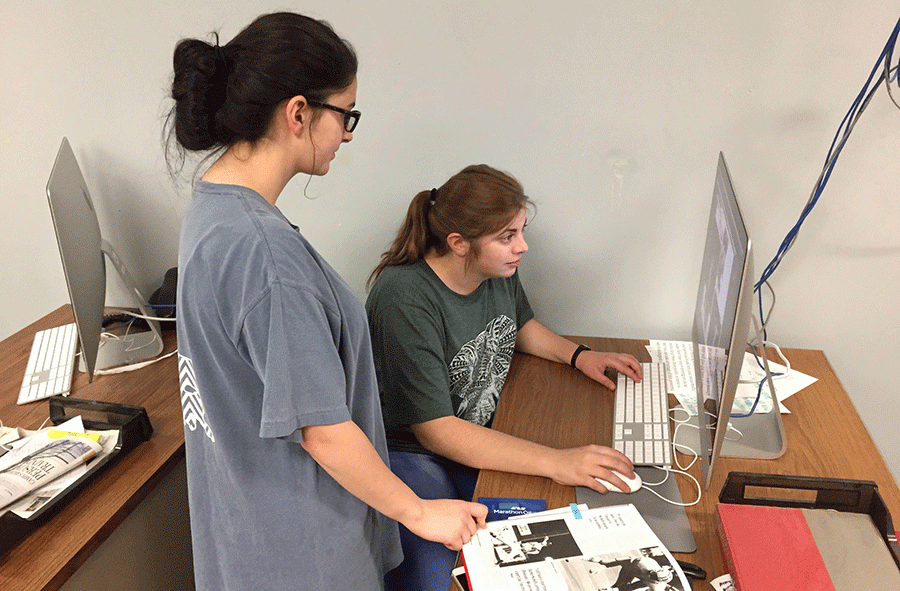 La Pirogue editor, Hollyn Millet, Education sophomore, helps section editor, Julia Boudreau, Management senior, create spreads for the 2016-2017 yearbook.