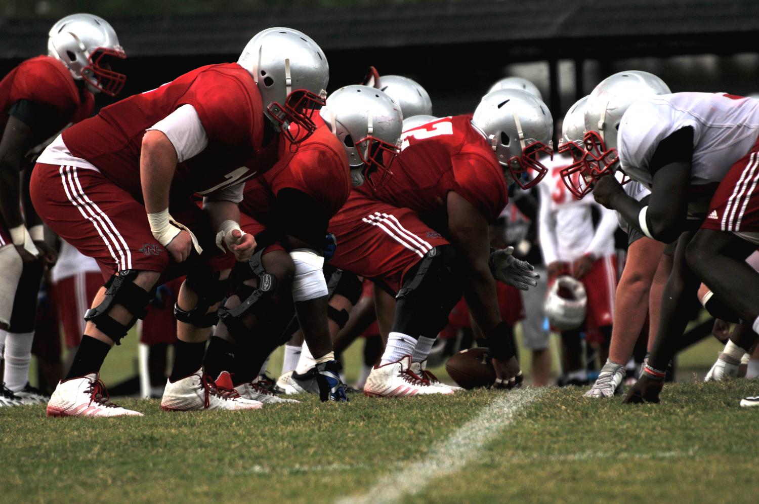 Offensive and defensive linemen get into formation on the line of scrimmage at afternoon practice on Tuesday, September 1.