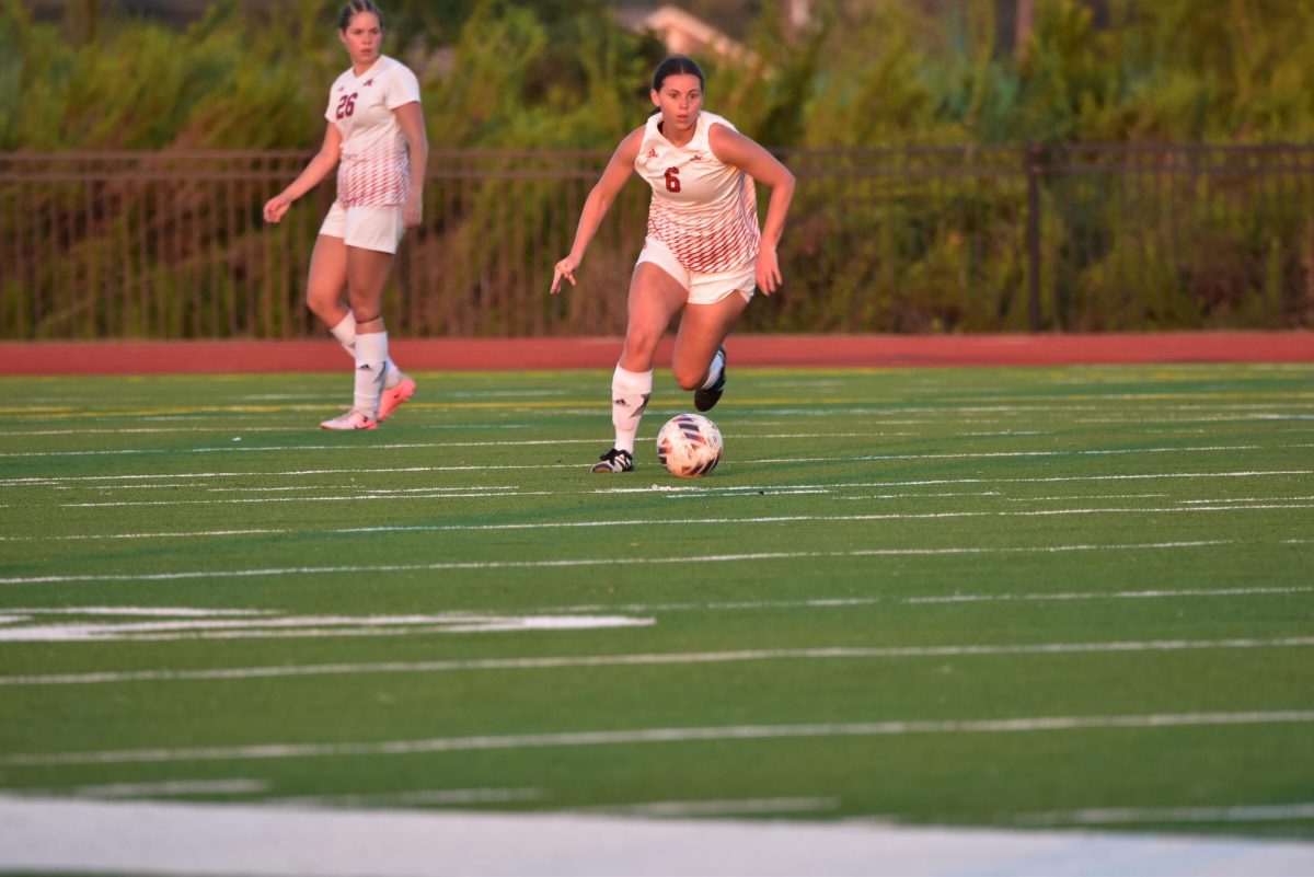 Nicholls midfielder Lillie Mazur[#6] running with the ball in a game against Southeastern(10/13/2024)