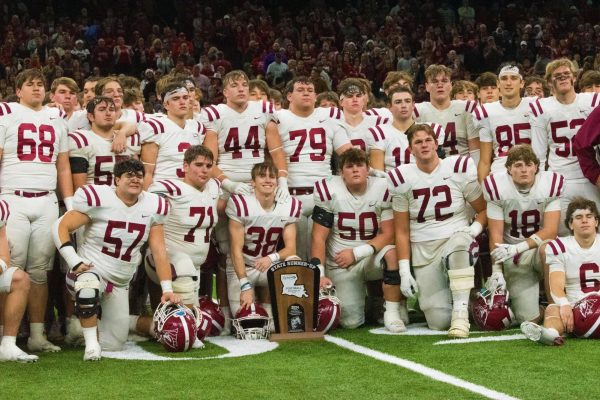 E.D> White football team holding state runners up trophy