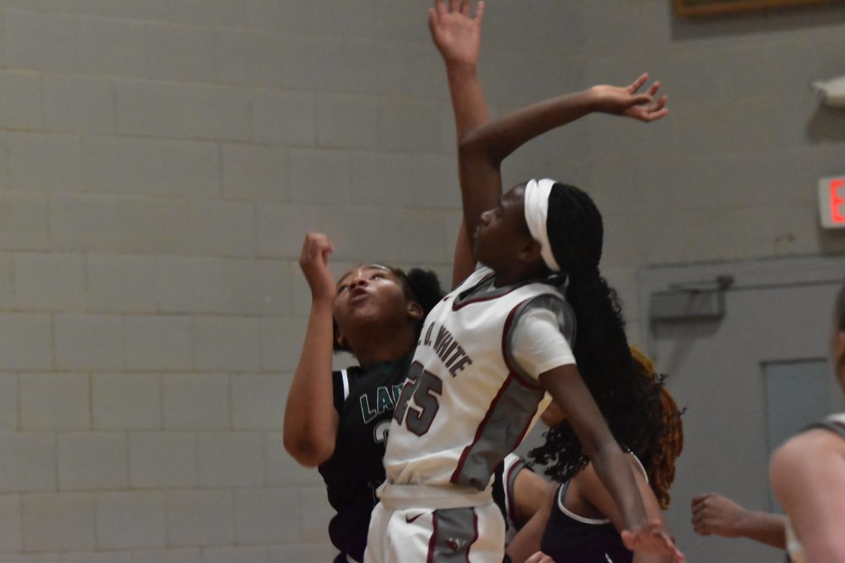 E.D. White girls' basketball player Immi Ingram jumps for a rebound in a game against Morgan City on Feb 7, 2025