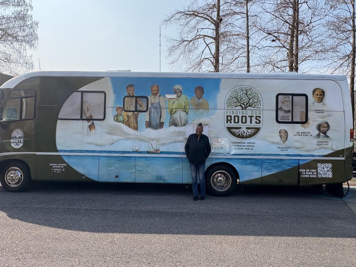 Founder and President of the "Finding Your Roots" mobile museum Margie Scoby standing in front the museum's RV at Nicholls State University on Feb. 13, 2025