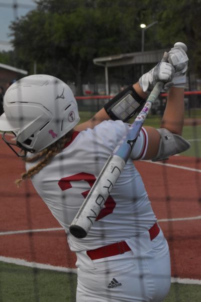 Claire Sisco taking practices swings before an at-bat