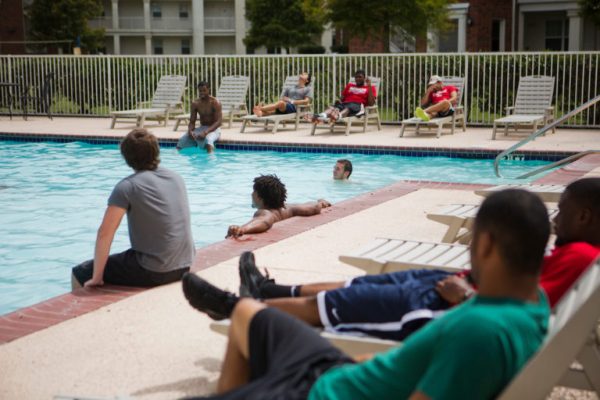 Nicholls' students lounging by Brady Pool.