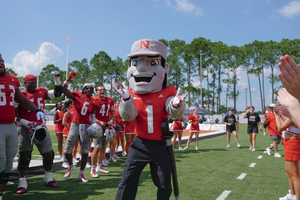 Colonel Tillou cheers along the sidelines.