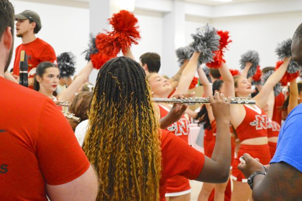 Nicholls bands play ensemble while the cheer team performs a routine at Welcome Back Day.