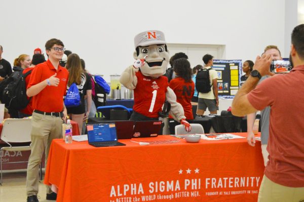 Colonel Tillou takes a picture with Alpha Sigma Phi at Welcome Back Day.