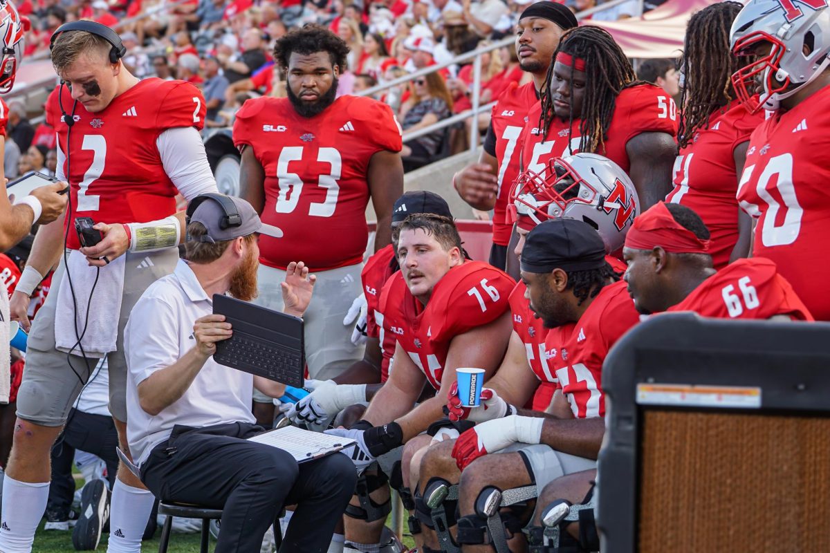 Colonels huddle on the sidelines.