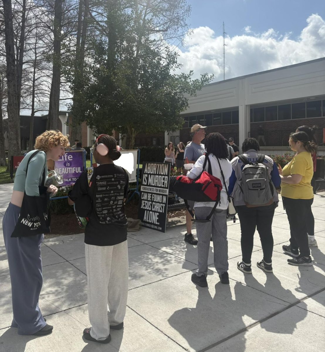 Students and passersby debate pro-lifer David in front of the Nicholls Student Union. Note: Photo edited by the Nicholls Worth to block 'graphic' imagery. 
