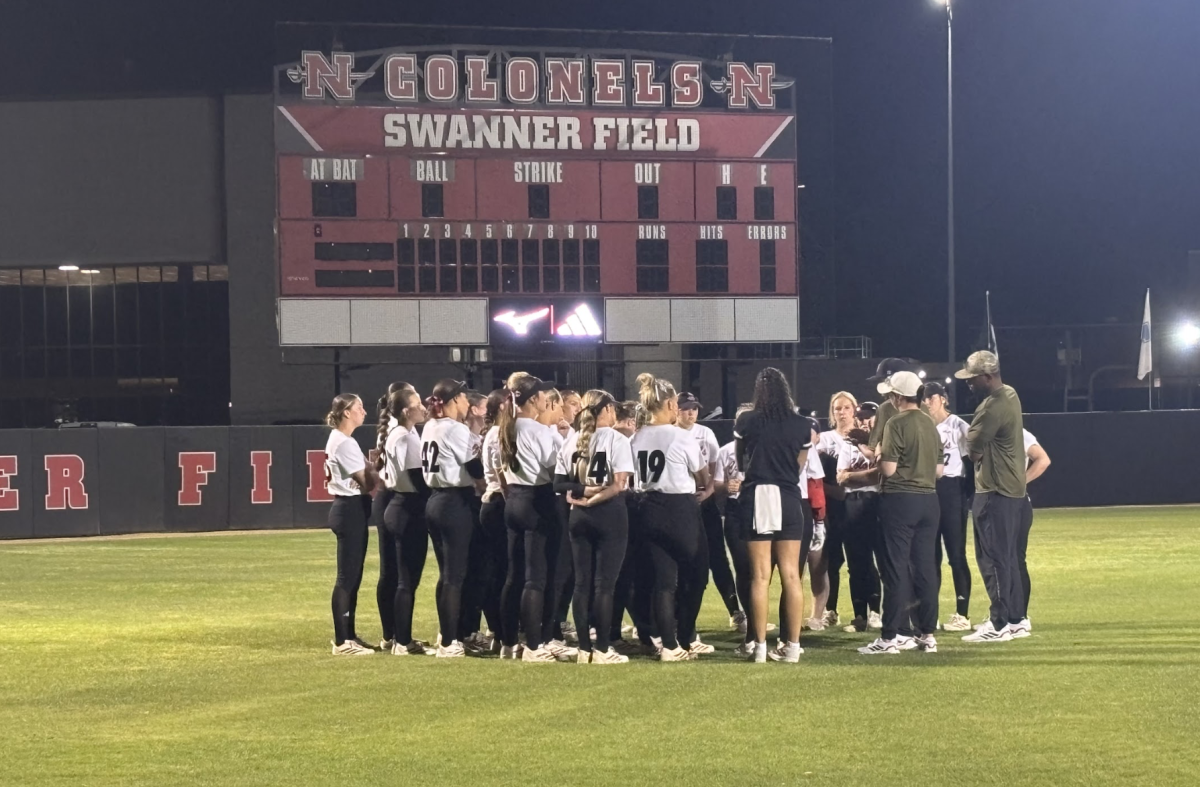 Nicholls softball team huddle after game. 