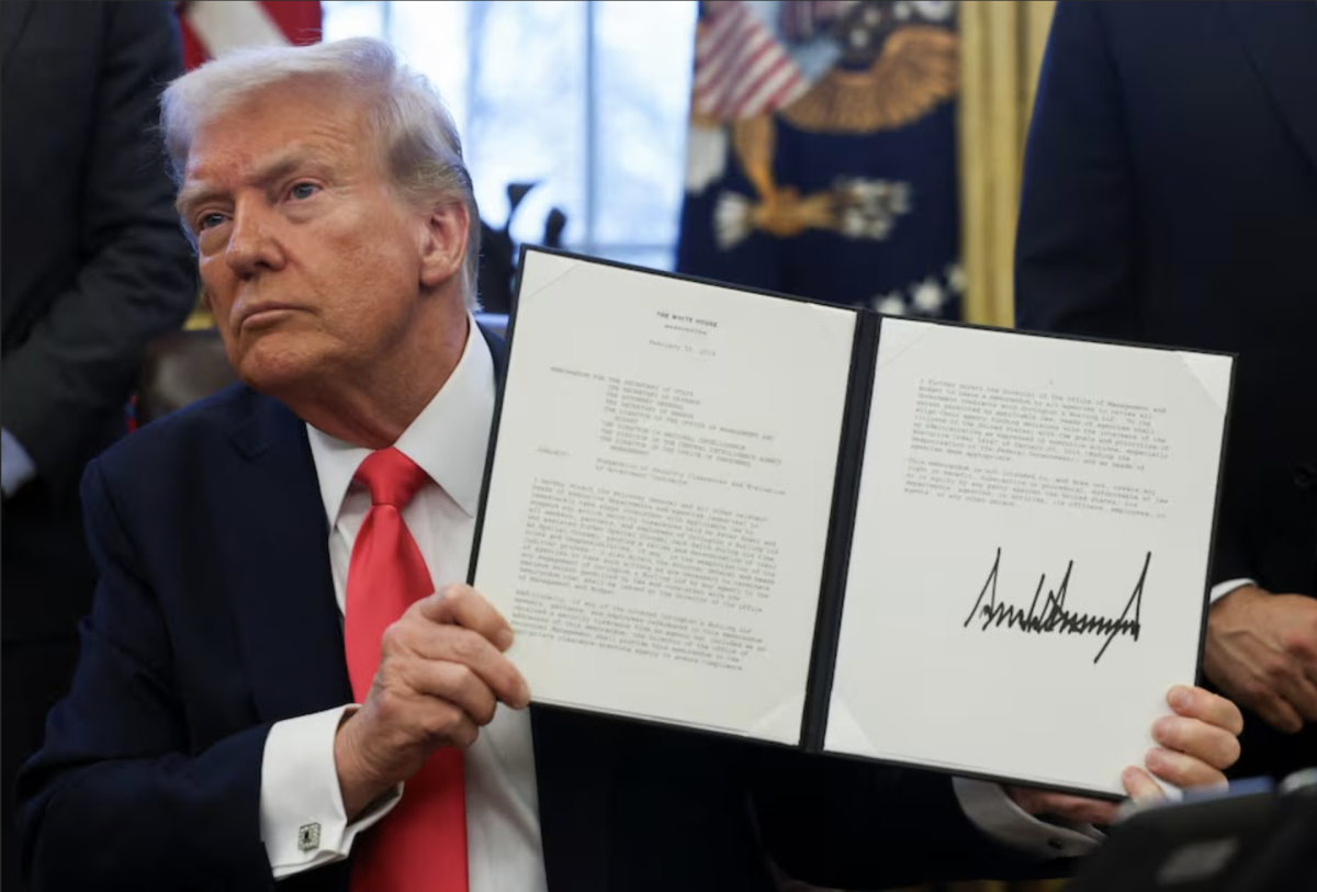 U.S. President Donald Trump holds an executive order signed in the Oval Office, at the White House in Washington, D.C. February 25, 2025. (Photo by: REUTERS/Evelyn Hockstein)